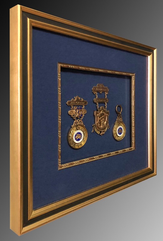 Side view of academic medals in a picture frame